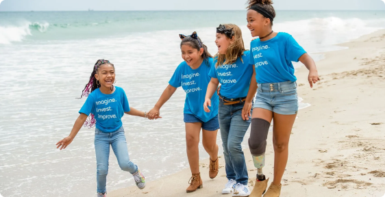 4 children running on the beach
