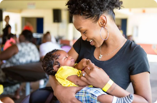 Woman smiling holding a child
